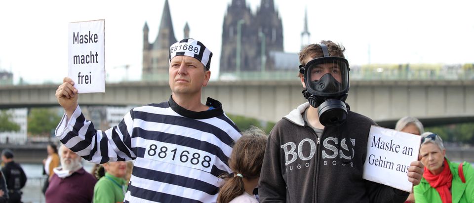 COLOGNE, GERMANY - MAY 23: Protesters gather to demonstrate against lockdown measures and government policy on the 71st anniversary of Germany's Basic Law during the coronavirus crisis on May 23, 2020 in Cologne, Germany. The protests, which include people from the far political left to the far right, from conspiracy theorists to anti-vaccinators, but also the simply disgruntled, have become a weekly event in cities across Germany despite the fact that authorities have eased most lockdown measures. (Photo by Andreas Rentz/Getty Images)