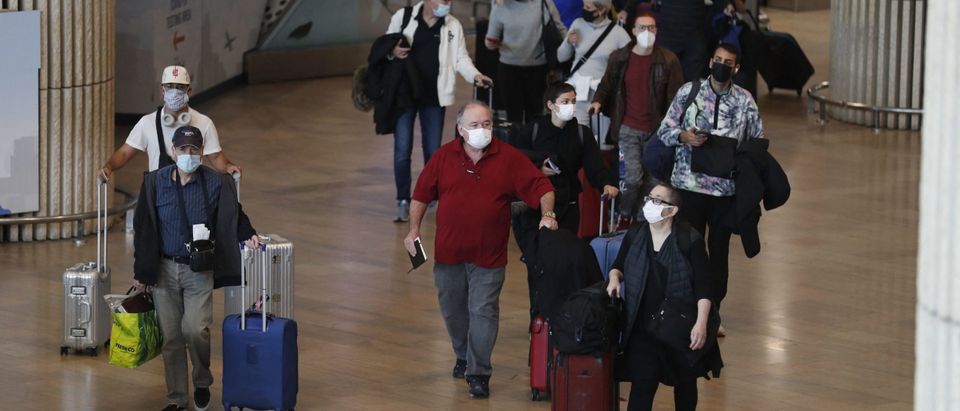 Passengers arrive to Israel's Ben Gurion Airport in Lod, east of Tel Aviv, on November 28, 2021. - Israel is to close its borders to all foreigners on November 28, 2021 in a bid to stem the spread of the new Omicron variant of the coronavirus, authorities said. The government's latest announcement came just hours before the start at sundown of the eight-day-long Jewish holiday of Hanukkah, the Festival of Lights. (Photo by Ahmad GHARABLI / AFP) (Photo by AHMAD GHARABLI/AFP via Getty Images)
