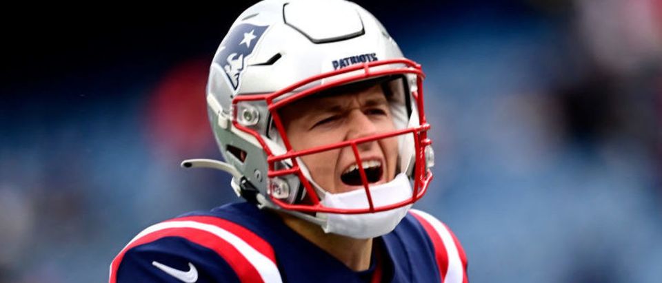 FOXBOROUGH, MASSACHUSETTS - NOVEMBER 28: Mac Jones #10 of the New England Patriots shouts during warm-up before the game against the Tennessee Titans at Gillette Stadium on November 28, 2021 in Foxborough, Massachusetts. (Photo by Billie Weiss/Getty Images)