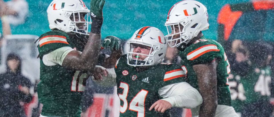 MIAMI GARDENS, FLORIDA - NOVEMBER 20: Ryan Ragone #34 of the Miami Hurricanes celebrates with teammates after sacking Braxton Burmeister #3 of the Virginia Tech Hokies during the first half at Hard Rock Stadium on November 20, 2021 in Miami Gardens, Florida. (Photo by Mark Brown/Getty Images)