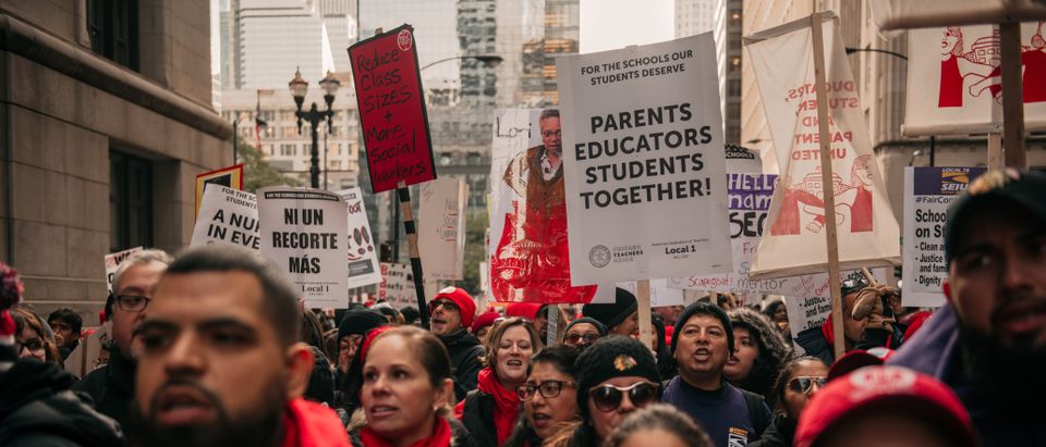Thousands of demonstrators take to the streets, stopping traffic and circling City Hall in a show support for the ongoing teachers strike on October 23, 2019 in Chicago, Illinois. Union teachers and school staff members are demanding more funding from the city in order to lower class sizes, hire more support staff, and build new affordable housing for the 16,000 Chicago Public Schools students whose families are homeless. (Photo by Scott Heins/Getty Images)