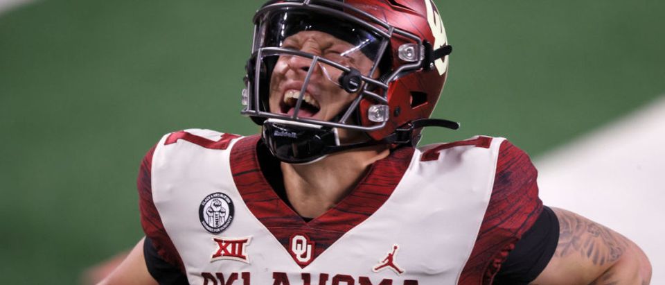 ARLINGTON, TEXAS - DECEMBER 19: Spencer Rattler #7 of the Oklahoma Sooners celebrates after scoring a touchdown against the Iowa State Cyclones in the second quarter of the 2020 Dr Pepper Big 12 Championship football game at AT&amp;T Stadium on December 19, 2020 in Arlington, Texas. (Photo by Tom Pennington/Getty Images)