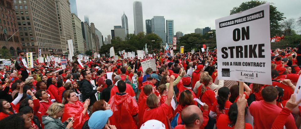 Striking Chicago public school teachers and their supporters rally following a march down Michigan Avenue on September 13, 2012 in Chicago, Illinois. More than 26,000 teachers and support staff walked off the job on September 10 after the Chicago Teachers Union failed to reach an agreement with the city on compensation, benefits and job security. With about 350,000 students, the Chicago school district is the third largest in the United States. (Photo by Scott Olson/Getty Images)