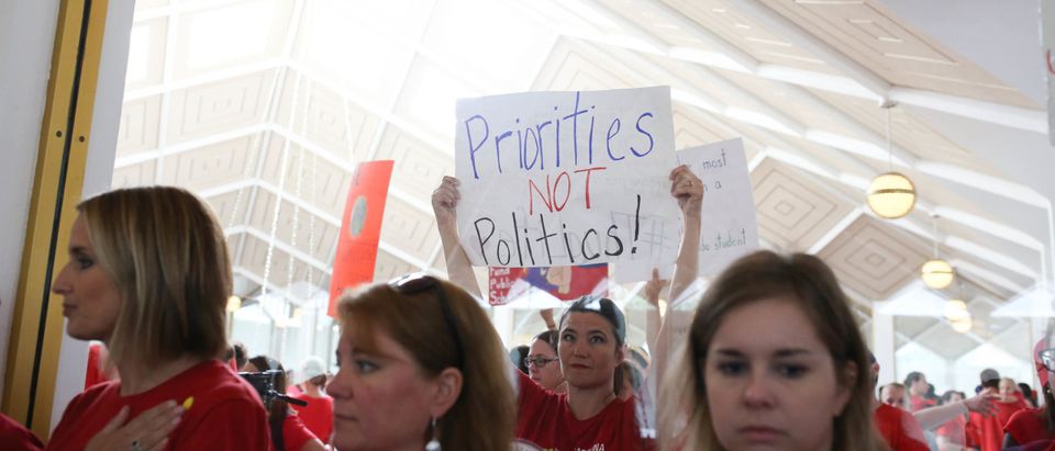Teachers from across the state of North Carolina march and protest outside the State Capitol building in Raleigh, on May, 16 2018. (Photo by LOGAN CYRUS/AFP via Getty Images)