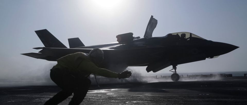 U.S. 5th FLEET AREA OF OPERATIONS (Sept. 27, 2018) U.S. Navy Petty Officer 1st Class Rey White, an aviation boatswains mate handler with the Essex Amphibious Ready Group (ARG), launches an F-35B Lightning II with Marine Fighter Attack Squadron 211, 13th Marine Expeditionary Unit (MEU), from the Wasp-class amphibious assault ship USS Essex (LHD 2), before the F-35B's first combat strike, Sept. 27, 2018. The Essex is the flagship for the Essex Amphibious Ready Group and, with the embarked 13th MEU, is deployed to the U.S. Fifth Fleet area of operations in support of naval operations to ensure maritime stability and security in the Central Region, connecting the Mediterranean and the Pacific through the western Indian Ocean and three strategic choke points. (Photo by Cpl. Francisco J. Diaz Jr./U.S. Marine Corps via Getty Images)