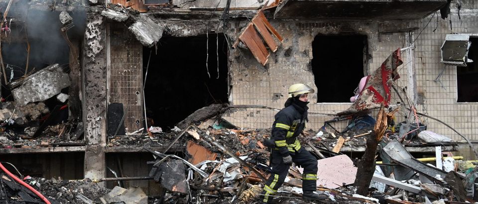 Firefighters work at a damaged residential building at Koshytsa Street, a suburb of the Ukrainian capital Kyiv, where a military shell allegedly hit, on February 25, 2022. - Invading Russian forces pressed deep into Ukraine as deadly battles reached the outskirts of Kyiv, with explosions heard in the capital early Friday that the besieged government described as "horrific rocket strikes". The blasts in Kyiv set off a second day of violence after Russian President Vladimir Putin defied Western warnings to unleash a full-scale ground invasion and air assault that quickly claimed dozens of lives and displaced at least 100,000 people. (Photo by GENYA SAVILOV / AFP) (Photo by GENYA SAVILOV/AFP via Getty Images)