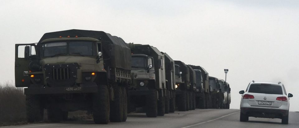 Russian military trucks and buses are seen on the side of a road in Russia's southern Rostov region, which borders the self-proclaimed Donetsk People's Republic, on February 23, 2022. (Photo by STRINGER / AFP) (Photo by STRINGER/AFP via Getty Images)