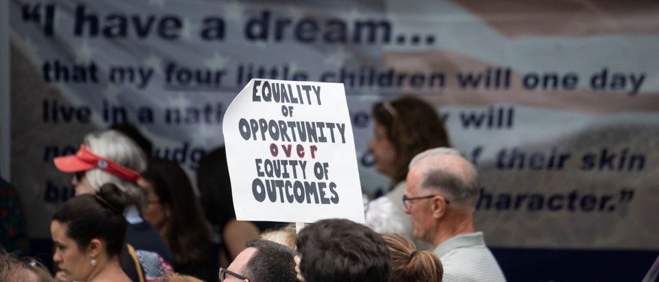 A participant holds up a sign during a rally against "critical race theory" (CRT) being taught in schools at the Loudoun County Government center in Leesburg, Virginia on June 12, 2021. (Photo by ANDREW CABALLERO-REYNOLDS/AFP via Getty Images)
