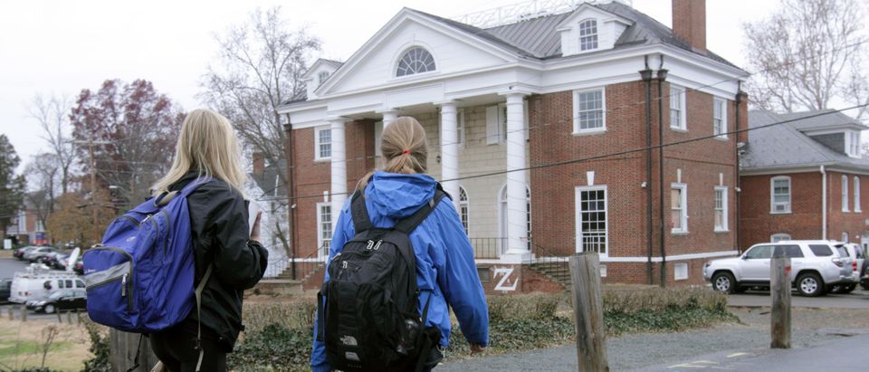 Students walk past the Phi Kappa Psi fraternity house on the University of Virginia campus on December 6, 2014 in Charlottesville, Virginia. On Friday, Rolling Stone magazine issued an apology for discrepencies that were published in an article regarding the alleged gang rape of a University of Virginia student by members of the Phi Kappa Psi fraternity. (Photo by Jay Paul/Getty Images)