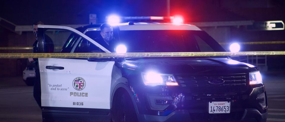 LAPD Officer blocks a street with a police vehicle following a shooting [Shutterstock/Elliott Cowand Jr.]
