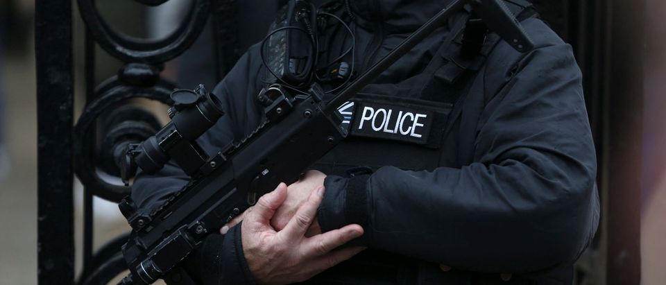 An armed police officer patrols in London