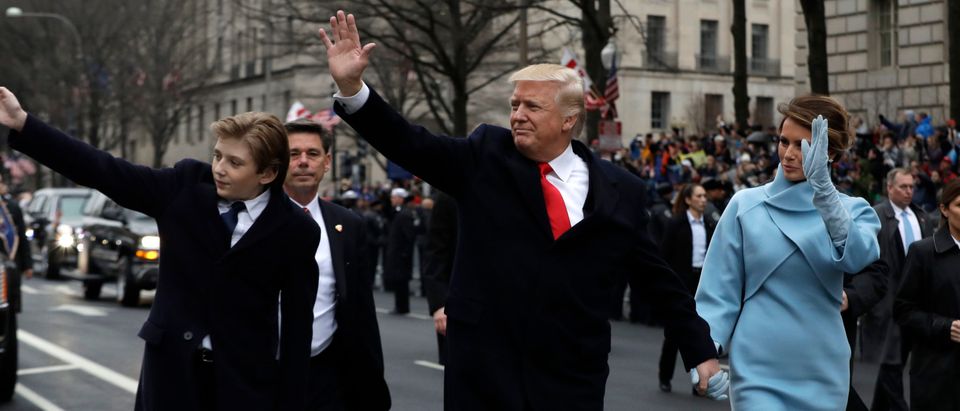 President Donald Trump waves as he walks with first lady Melania Trump and their son Barron, left, during the inauguration parade on Pennsylvania Avenue in Washington, Friday, Jan. 20, 2016. REUTERS/Evan Vucci/Pool