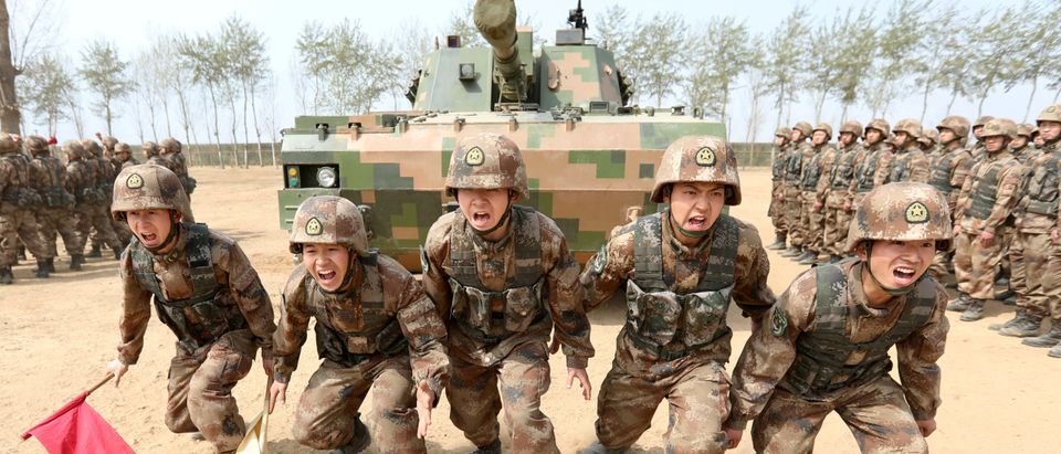 Soldiers of China's People's Liberation Army (PLA) are seen during a military promotional event in Baoding