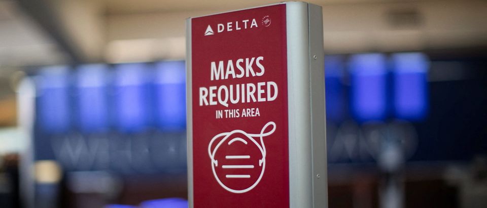 An outdated sign requiring Delta Air Lines passengers to wear a face mask to board a plane is displayed in the domestic terminal of the Hartsfield-Jackson Atlanta International Airport after Biden's administration announced that it will no longer enforce a U.S. mask mandate on public transportation, following a Florida court ruling, in Atlanta, Georgia, U.S., April 19, 2022. REUTERS/Alyssa Pointer