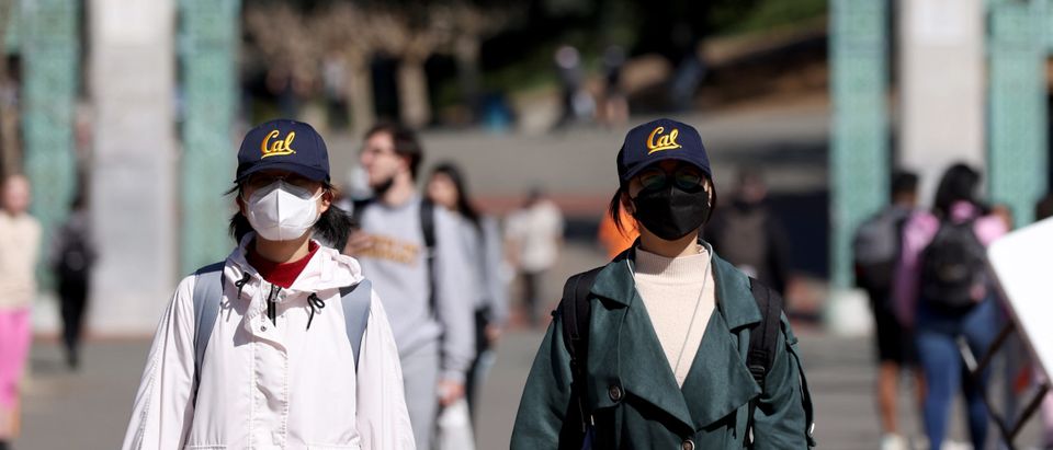 Students wear UC Berkeley school apparel as they walk through Sproul Plaza on the UC Berkeley campus on March 14, 2022 in Berkeley, California. UC Berkeley is set to cut on-campus enrollment by a minimum of 2,500 students for fall enrollment due to an extreme shortage of affordable housing. Many college towns in California are facing similar shortages due to construction restraints. (Photo by Justin Sullivan/Getty Images)
