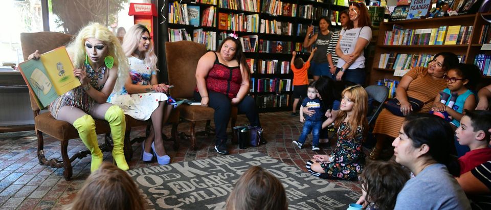 Drag queens Athena Kills (C) and Scalene Onixxx arrive to awaiting adults and children for Drag Queen Story Hour at Cellar Door Books in Riverside, California on June 22, 2019. (Photo by FREDERIC J. BROWN/AFP via Getty Images)
