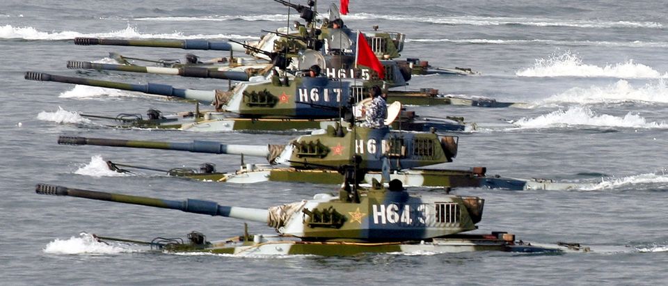 QINGDAO, CHINA - AUGUST 22: (CHINA OUT) Amphibious tanks of the Chinese People's Liberation Army move to land a beach during the second phase of the Sino-Russian joint military exercise on August 22, 2005 near Qingdao of Shandong Peninsular, China. The second phase of the on-going "Peace Mission 2005" joint military exercise by Chinese and Russian armies was held on August 20, focusing on the transportation and outspread of troops, decision making and adjustment, and organization of coordinated actions. The third stage of the drills will start on August 23, more than 7,000 Chinese troops and 1,800 Russians with military vessels, fighter jets and amphibious tanks will start a three-day live ammunition combat practice, according to state media. (Photo by China Photos/Getty Images)