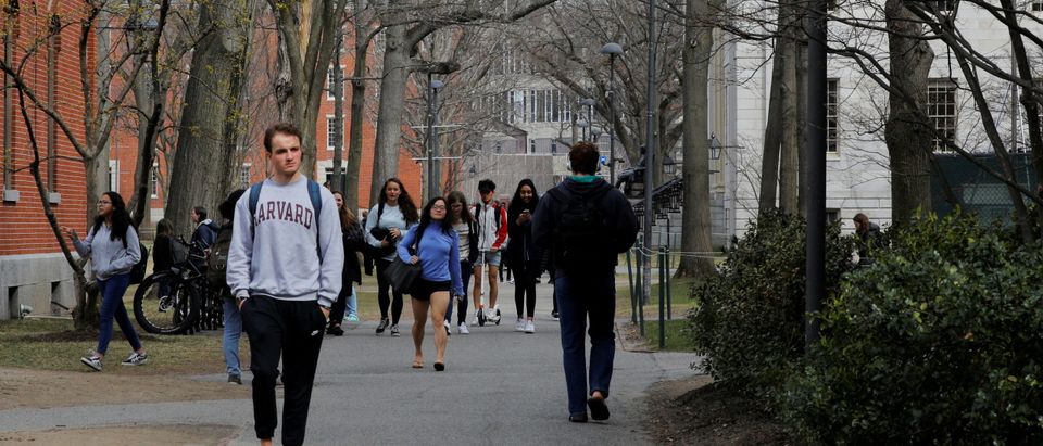 Students and pedestrians walk through the Yard at Harvard University in Cambridge, Massachusetts, U.S., March 10, 2020. REUTERS/Brian Snyder/File Photo