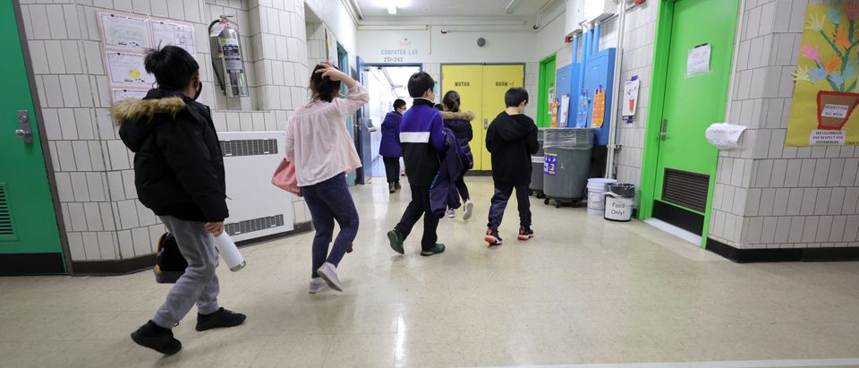 Students are led to their classroom by a teacher at Yung Wing School P.S. 124 on March 07, 2022 in New York City.(Photo by Michael Loccisano/Getty Images)