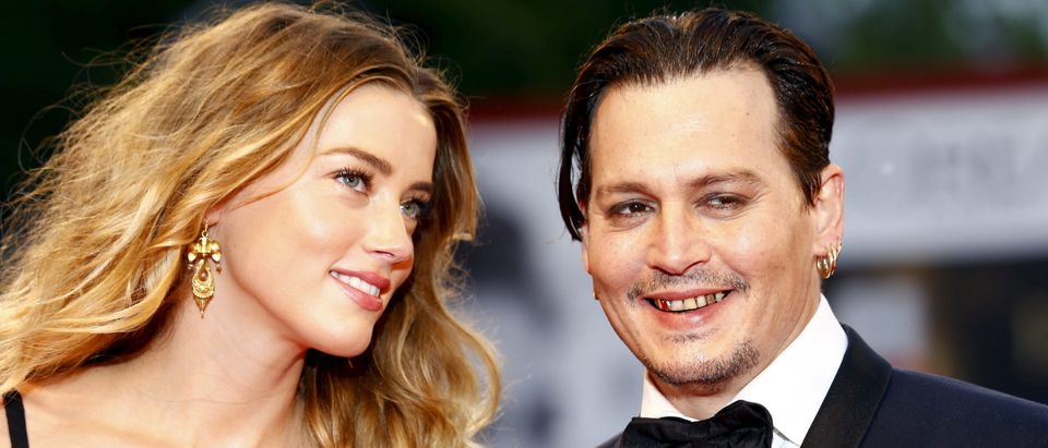 Actor Johnny Depp and his wife Amber Heard attend the red carpet event for the movie "Black Mass" at the 72nd Venice Film Festival