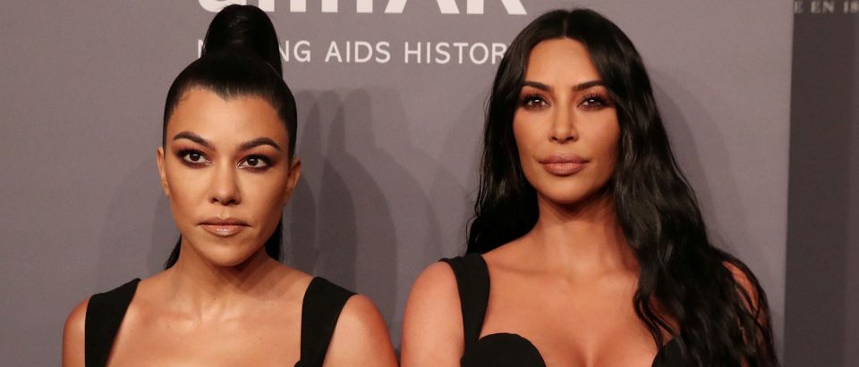 Kim Kardashian and her sister Kourtney Kardashian pose on the red carpet for the amfAR gala in New York