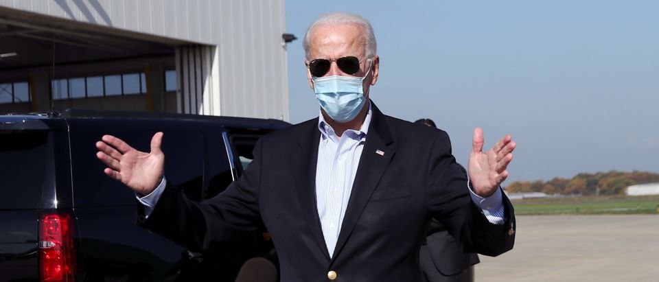 U.S. Democratic presidential candidate Joe Biden wearing a face mask speaks to the news media before boarding a plane to Nashville to take part in the second presidential debate, at New Castle Airport, New Castle, Delaware, U.S., October 22, 2020. REUTERS/Leah Millis
