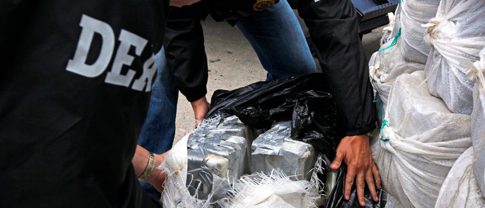 U.S. Drug Enforcement Administration officers display part of the 1280 kg (2822 pounds) of cocaine, which is worth an estimated $37 million, seized in a routine patrol during a media presentation in San Juan, May 6, 2014. REUTERS/Ana Martinez 