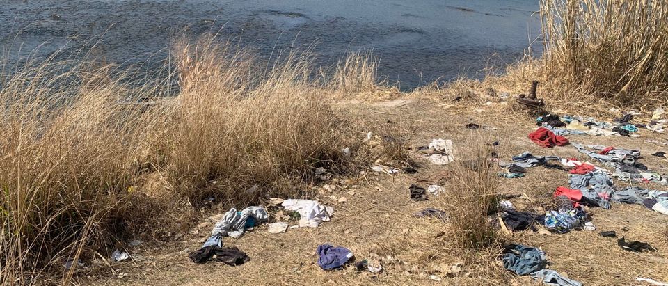 Wet clothes sit along the river where migrants have crossed from Mexico into Del Rio, Texas