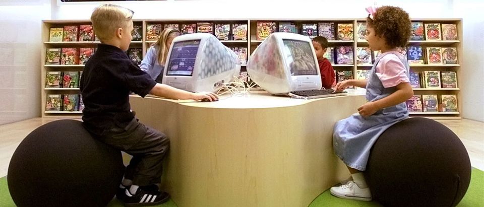 CHILDREN PLAY AT COMPUTERS IN KIDS SECTION OF APPLES FIRST RETAIL STORE.