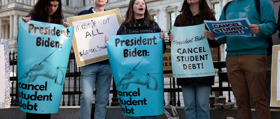 Activists hold signs as they attend a Student Loan Forgiveness rally on Pennsylvania Avenue and 17th street near the White House on April 27, 2022 in Washington, DC. Student loan activists including college students held the rally to celebrate U.S. President Joe Biden's extension of the pause on student loans and also urge him to sign an executive order that would fully cancel all student debt. (Photo by Anna Moneymaker/Getty Images)