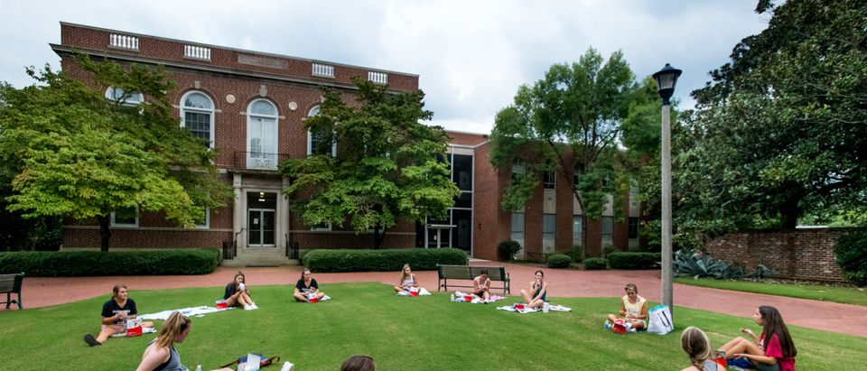 College students eat dinner outside at the University of South Carolina on August 10, 2020 in Columbia, South Carolina. Students began moving back to campus housing August 9 with classes to start August 20. (Photo by Sean Rayford/Getty Images)