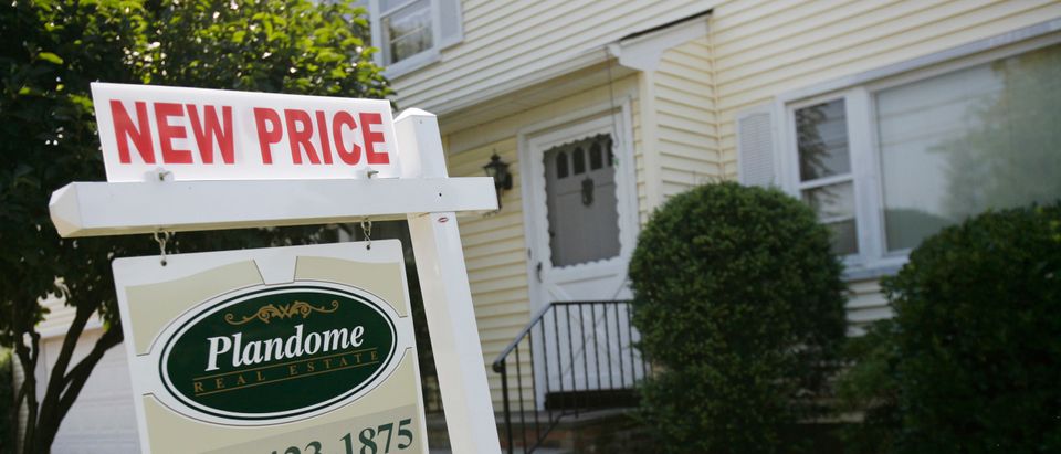 A listing for a new price on a home for sale is seen on a sign in Manhasset