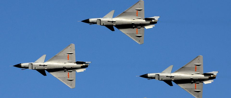 J-10 fighter jet aerobatic team of China Air Force fly in formation during a rehearsal for the upcoming 60th anniversary of the founding of China Air Force near an airport on the outskirts of Beijing, October 31, 2009. Picture taken October 31, 2009. China's People's Liberation Army (PLA) airforce will put its most advanced warplanes on display in the suburbs of Beijing in November, to mark the 60th founding anniversary of the PLA airforce, an airforce officer said. This year marks the 60th founding anniversary of the People's Republic of China, its naval forces on April 23, and its airforce on Nov. 11, Xinhua News Agency reported. (REUTERS/Joe Chan)