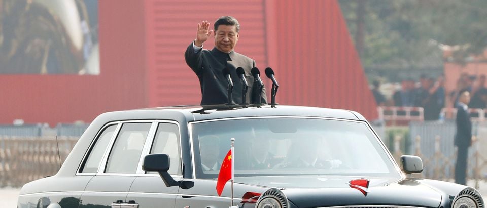 Chinese President Xi Jinping waves from a vehicle as he reviews the troops at a military parade marking the 70th founding anniversary of People's Republic of China, on its National Day in Beijing, China October 1, 2019. (REUTERS/Thomas Peter)