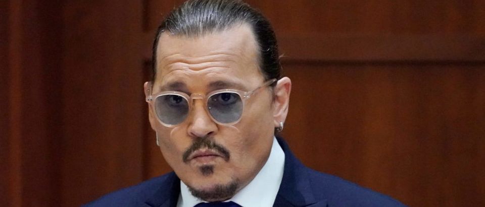 Actor Johnny Depp sits to testify in the courtroom at the Fairfax County Circuit Courthouse in Fairfax, Virginia, U.S., April 25, 2022. Steve Helber/Pool via REUTERS