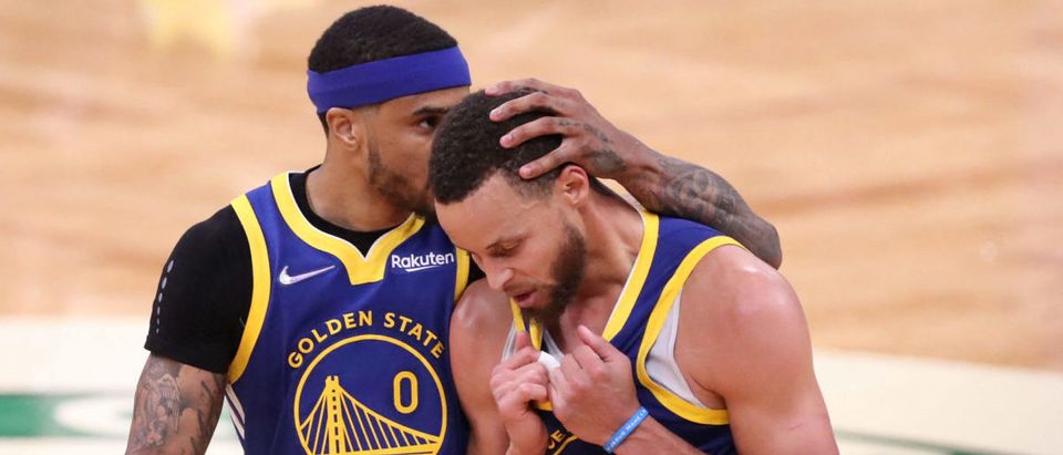 Jun 16, 2022; Boston, Massachusetts, USA; Golden State Warriors guard Gary Payton II (0) embraces guard Stephen Curry (30) after defeating the Boston Celtics in game six of the 2022 NBA Finals at the TD Garden. Mandatory Credit: Paul Rutherford-USA TODAY Sports via Reuters
