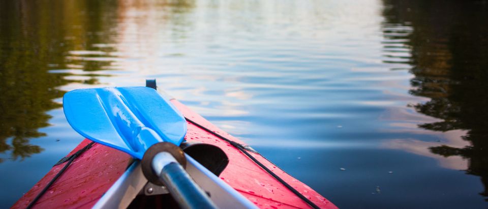 Two paddles lying on kayak. This image does not represent the incident mentioned in the story. [Shutterstock/lkoimages]