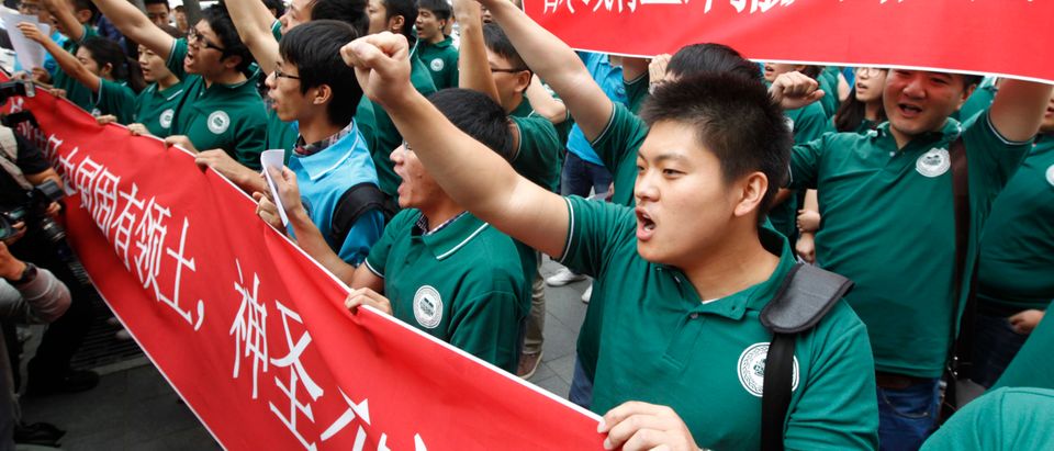 Members of the Chinese Students and Scholars Association in Korea chant slogans denouncing Japan during an anti-Japan protest near the Japanese embassy in Seoul September 20, 2012. Tension had run high due to the territorial dispute over the uninhabited group of islands in the East China Sea - known as the Senkaku in Japan and Diaoyu in China, with major demonstrations recently across China and Japanese and Chinese boats stalking each other in waters around the group of East China Sea islands. (REUTERS/Lee Jae-Won)