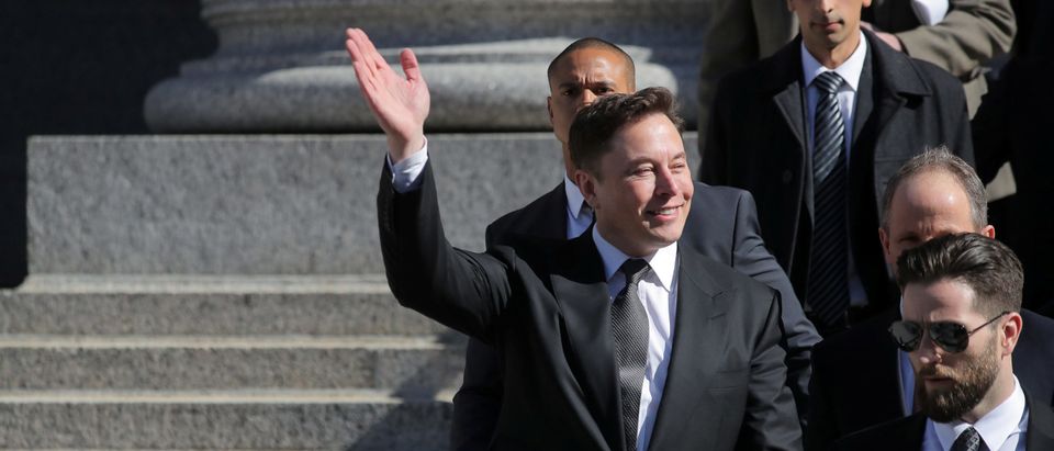 Tesla CEO Elon Musk waves at Manhattan federal court after a hearing on his fraud settlement with the SEC in New York