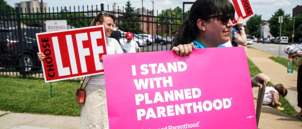 Pro-Choice and Pro-Life protesters stand outside of Planned Parenthood as a deadline looms to renew the license of Missouri's sole remaining Planned Parenthood clinic in St. Louis, Missouri