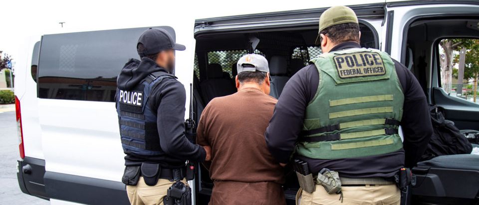 U.S. Immigration and Customs Enforcement officers make an arrest after carrying out a raid in San Francisco