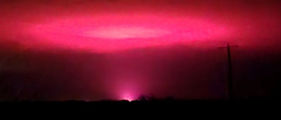 Pink glow lights up the sky above of Australian town