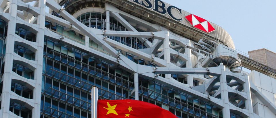 A Chinese national flag flies in front of HSBC headquarters in Hong Kong