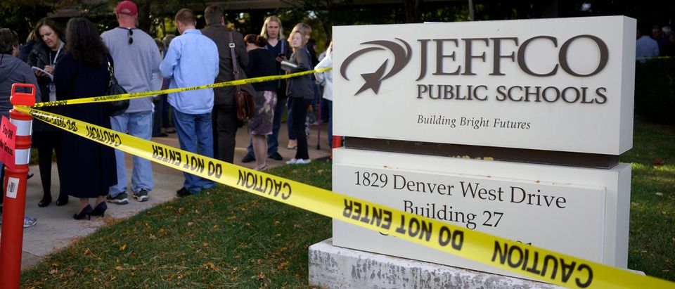 Police barrier tape is seen wrapped around the building sign outside the site of a Jefferson County school board meeting in Golden