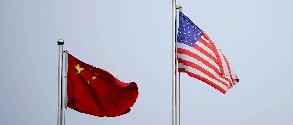 FILE PHOTO: Chinese and U.S. flags flutter outside a company building in Shanghai