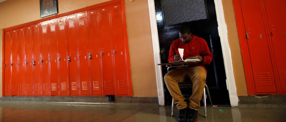 A student take a test in the hallway outside the classroom at Leo Catholic High School in Chicago, Illinois