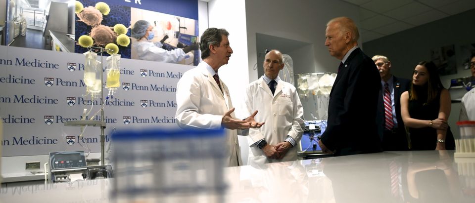 (L-R) Dr. Bruce Levine and Dr. Carl June, speak with Vice President Joe Biden during a tour at the University of Pennsylvania, Perelman School of Medicine and Abramson Cancer Center in Philadelphia, Pennsylvania