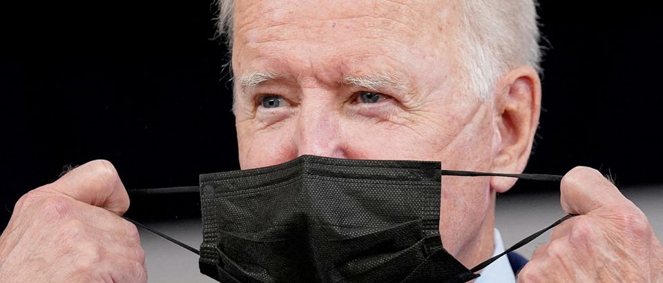 President Joe Biden removes his face mask prior to receiving his coronavirus disease (COVID-19) booster vaccination in the Eisenhower Executive Office Building's South Court Auditorium at the White House in Washington, U.S., September 27, 2021.