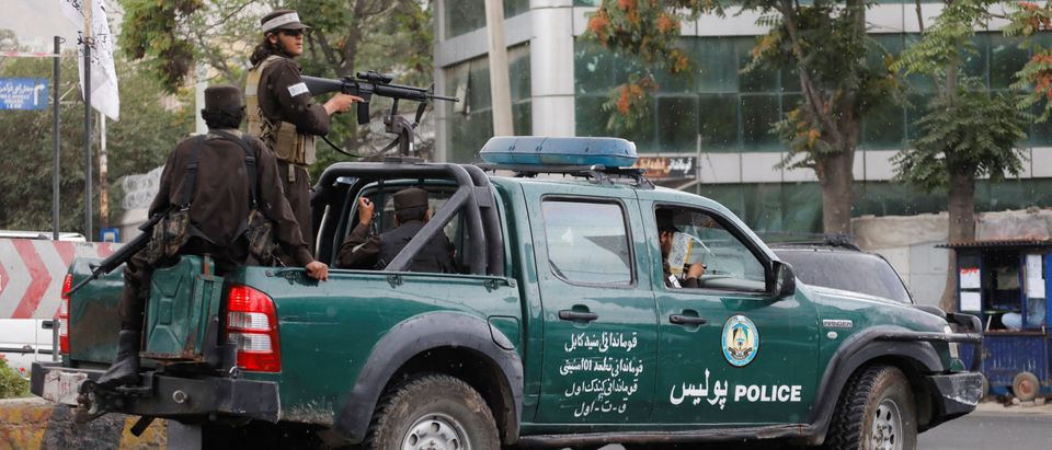 Taliban fighters drive a car on a street following the killing of Al Qaeda leader Ayman al-Zawahiri in a U.S. strike over the weekend, in Kabul