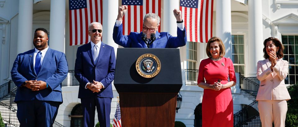 Flanked by U.S. President Joe Biden (L) and Speaker of the House Nancy Pelosi (D-CA), Senate Majority Leader Chuck Schumer (D-NY) gestures as he speaks before Biden signs the CHIPS and Science Act of 2022 during a ceremony on the South Lawn of the White House on August 9, 2022 in Washington, DC.